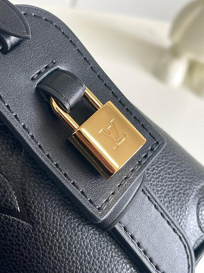Modern Refined Monogram Leather Bucket Bag